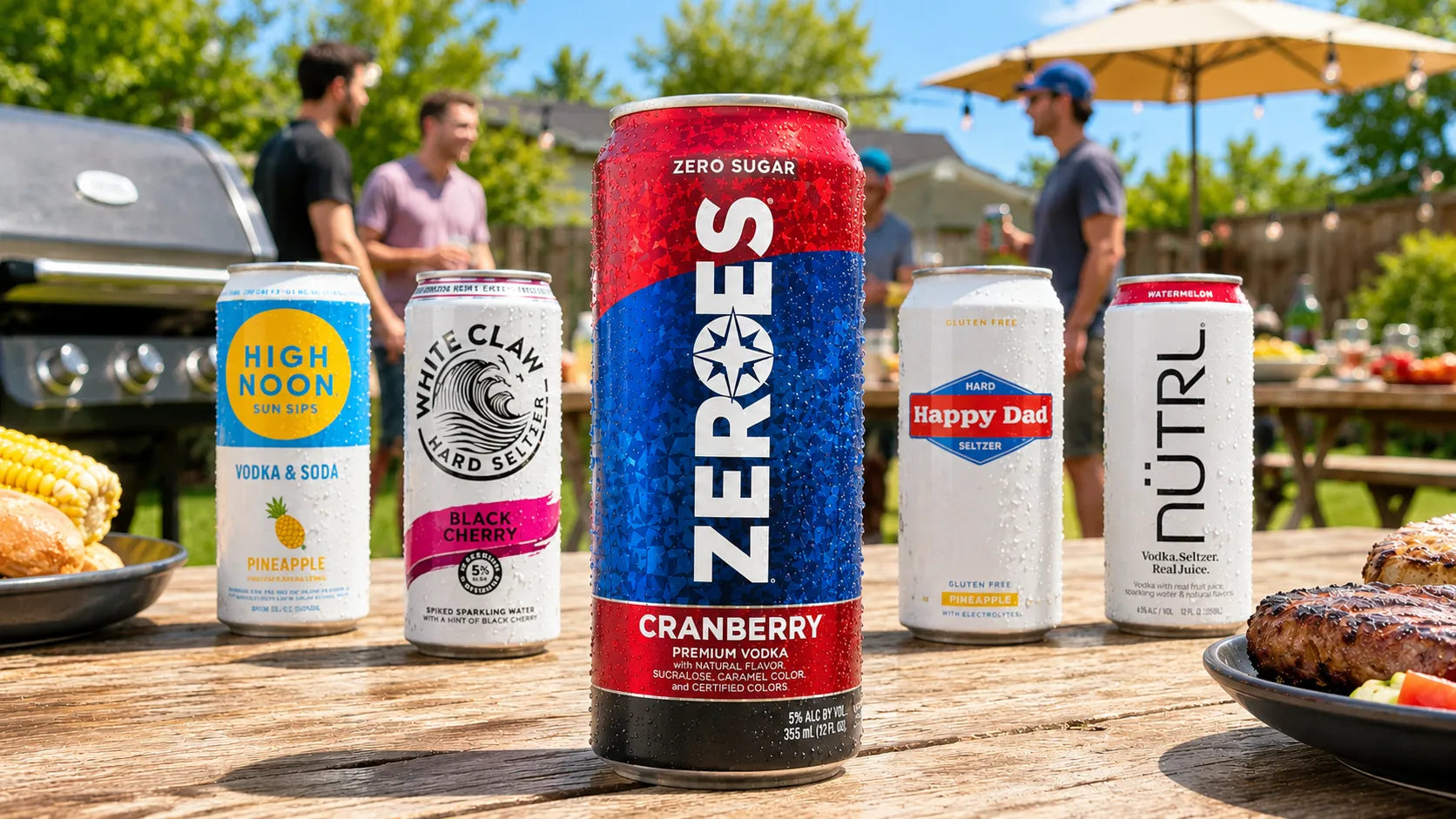 Cans of various drinks including ZEROS Cranberry on a wooden table outdoors with people in the background.